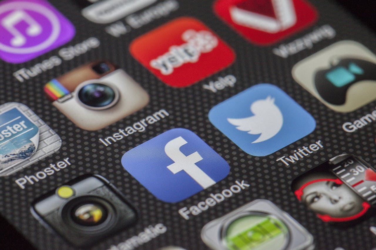 hero-img Close-up image of various social media app icons on a smartphone screen.