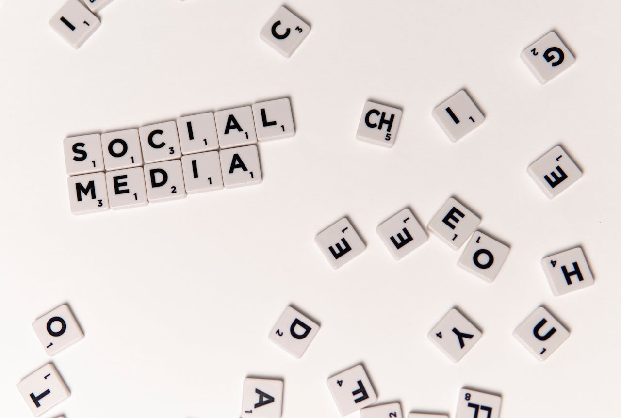 about-01 Scrabble tiles spelling Social Media on a white background, symbolizing digital communication.
